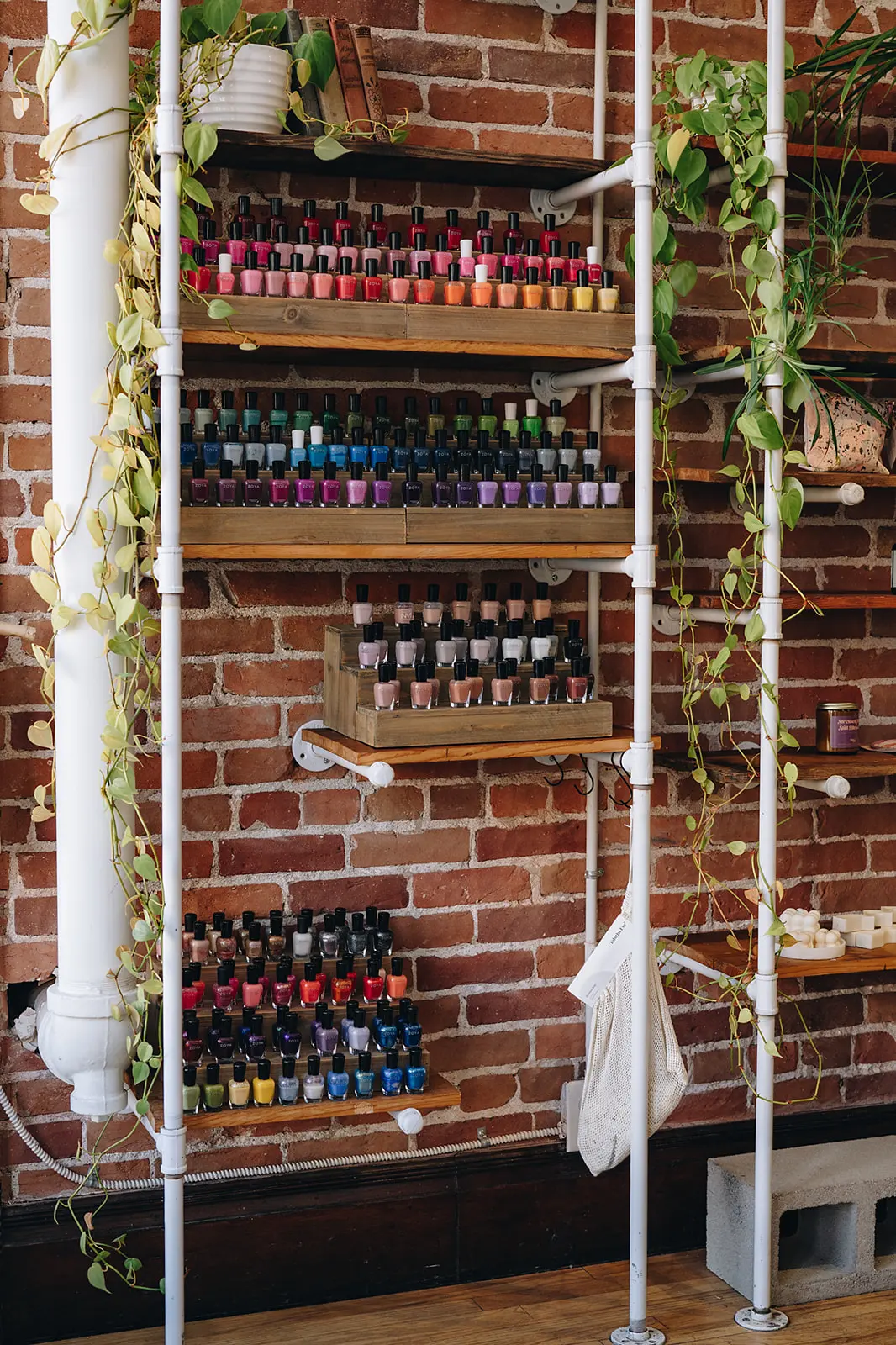 Zoya nail polish on industrial shelf with plant vines hanging down