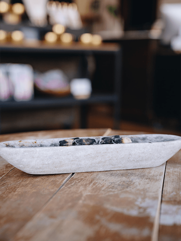 Palo santo burning inside our Nail Salon on a wooden table