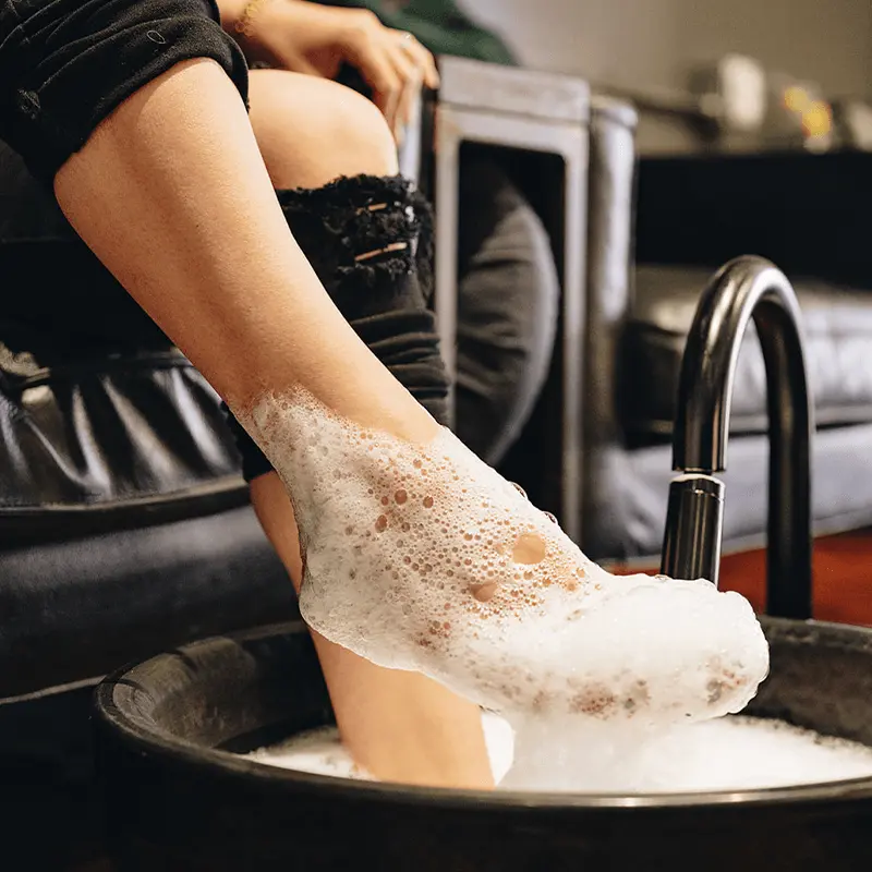 Foot in pedicure bath with bubbles