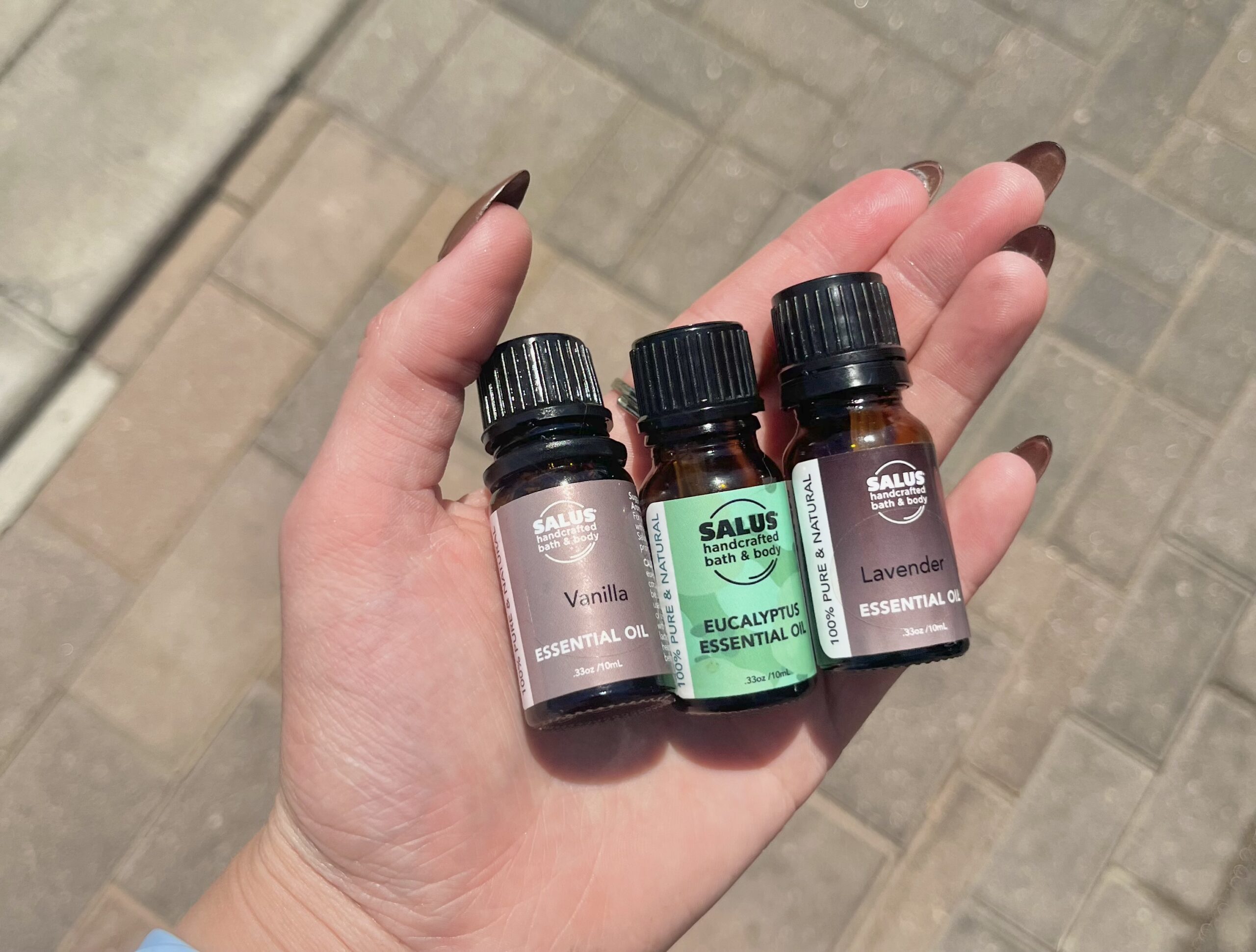 Holding essential oils (eucalyptus, lavender, and vanilla)